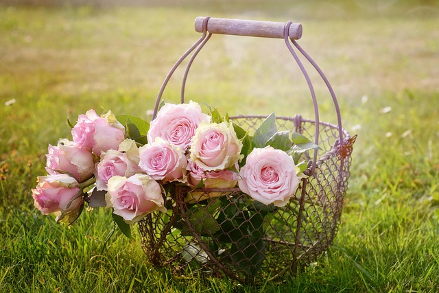 Florist at Balenqui flower farm arranging a bridal bouquet with garden roses peonies and trailing jasmine at a wooden workbench